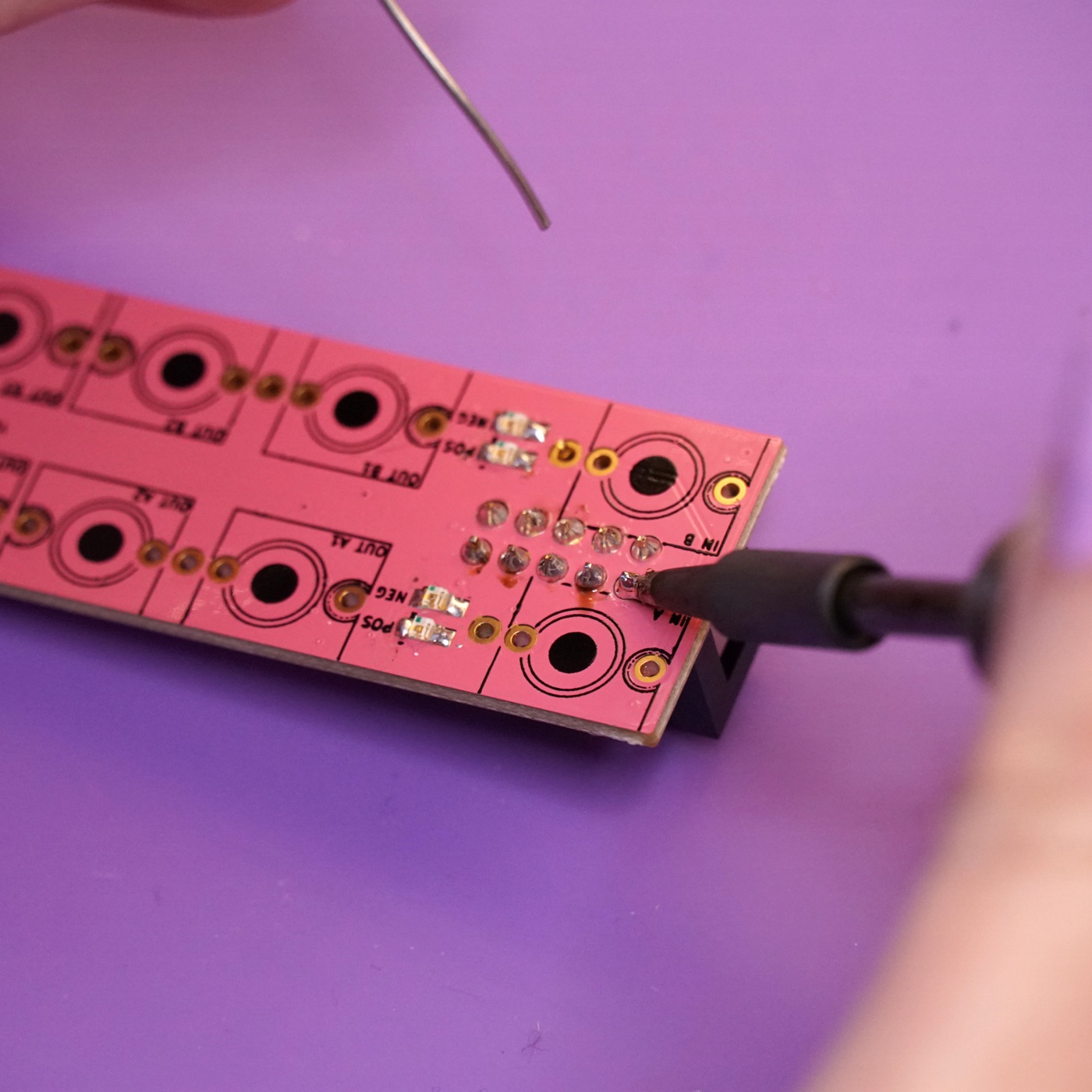 The power header being soldered to the mainboard